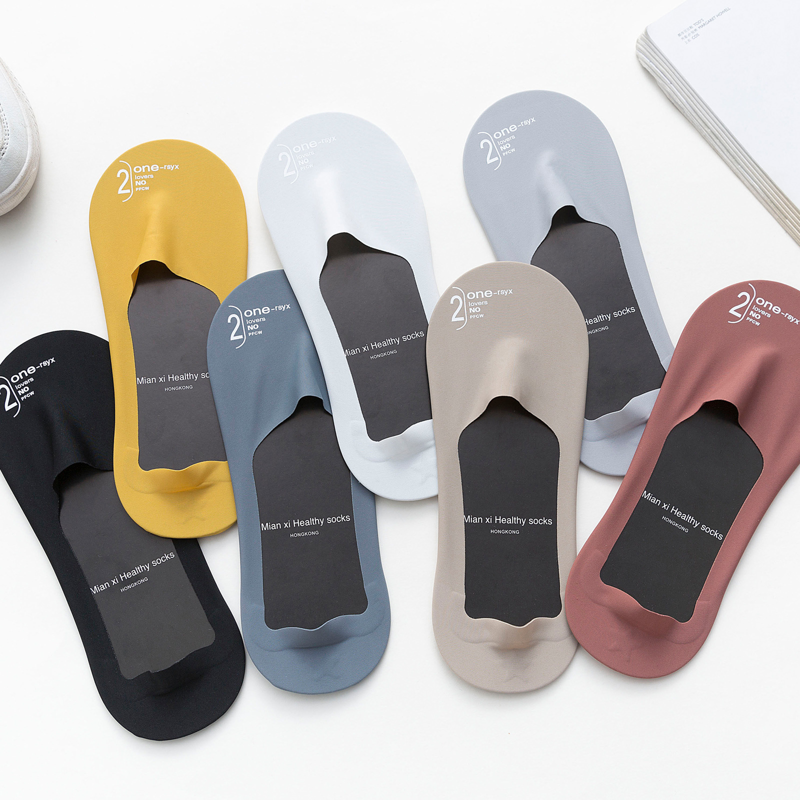 Set of six pairs of socks in various colors on a white background