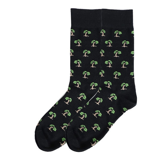 A pair of black socks with a green and brown tree pattern.