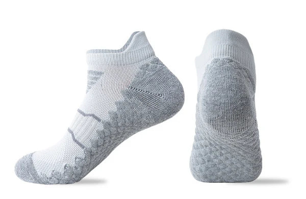 A pair of light blue sports ankle socks designed with a non-slip grip pattern.