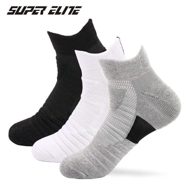 Three pairs of sports socks in white, black, and gray colors, Pedal favs. The socks are designed for comfort and fit, with visible texture indicating elasticity.