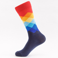 A crew sock with a colorful argyle pattern in red, blue, orange, and purple, positioned to show the color and pattern at the ankle area.